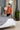 woman fixing bed cover